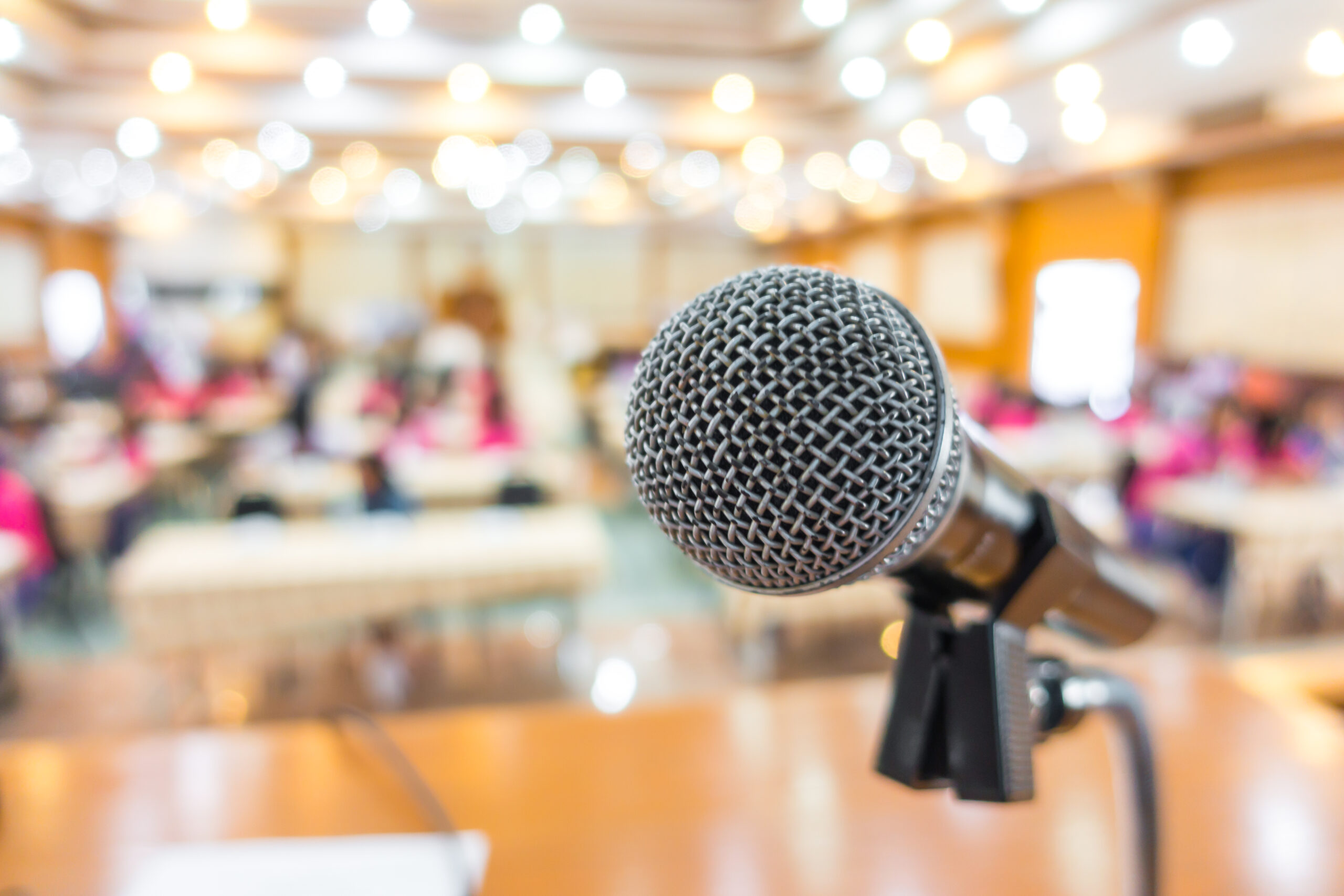 a microphone in front of conference attendees