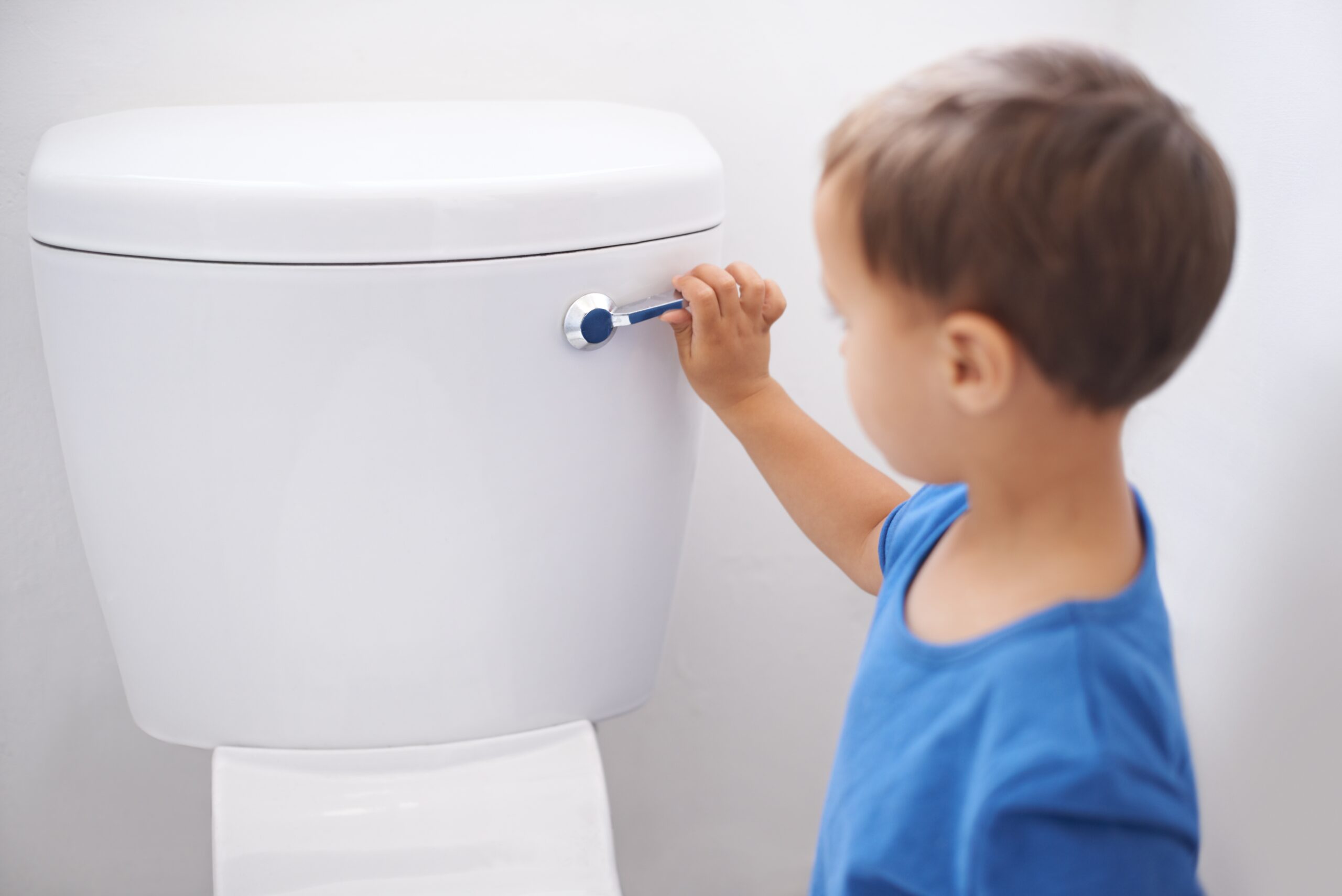 a child flushing a toilet
